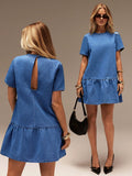 A woman modeling a short-sleeve denim mini dress, shown from both the front and back against a plain studio background. The dress has a ruffled hem and a back keyhole cutout.