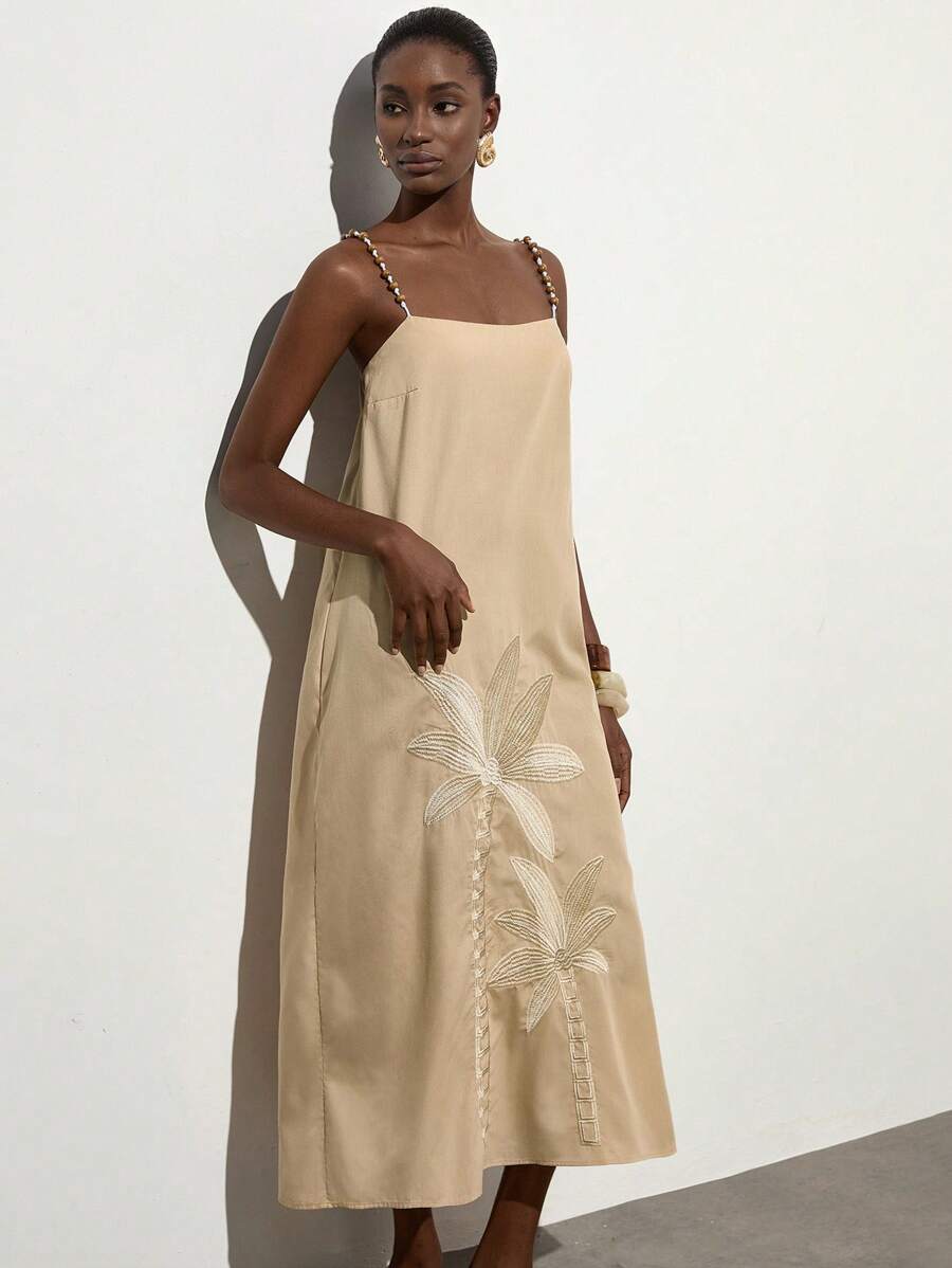 Step into vacation mode with this Elegant Beige Dress, featuring charming coconut tree embroidery and delicate straps. Perfect for sunny days and casual luxury, it blends comfort with a playful tropical vibe. Whether you're strolling the beach or sipping cocktails, this dress adds a breezy, stylish touch to your getaway wardrobe.
