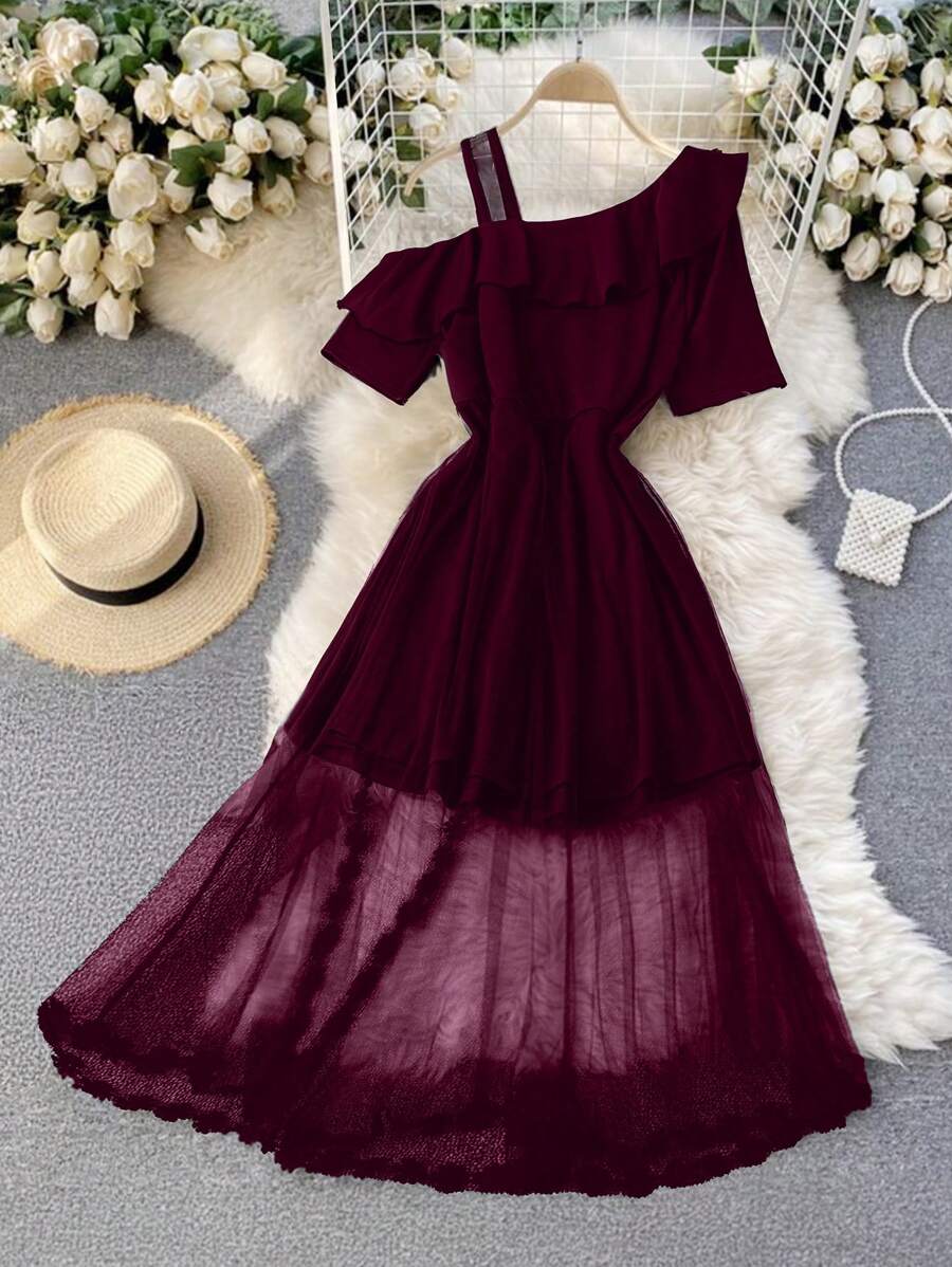 Turn heads with this Elegant Plus Size Burgundy Dress designed to celebrate every curve. Its playful asymmetric hem adds a flirty twist, while sheer mesh panels bring a touch of daring elegance. Perfect for dancing the night away or making a stylish statement at any event. Feel confident, comfortable, and fabulously you!
