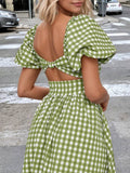 Back close view green white gingham dress with puff sleeves, open back, and tie detail