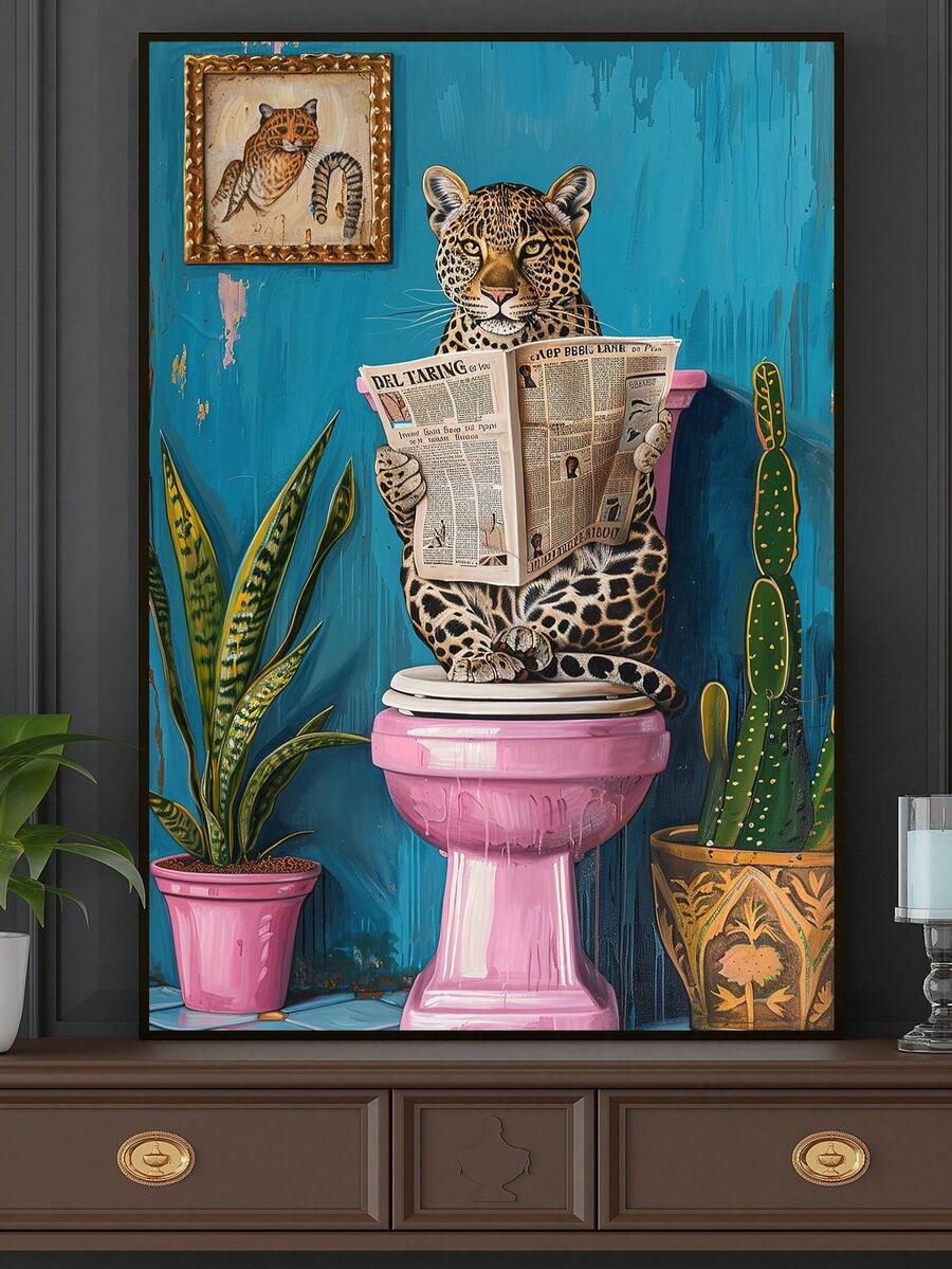 Black framed quirky leopard canvas print displayed above a wood cabinet with plants and a cup