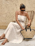 Seated front view of apricot tube dress showing double ruffle bodice and slub woven texture
