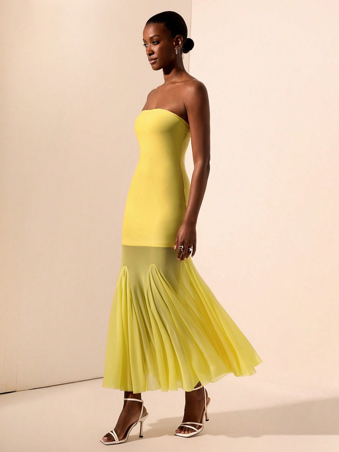 Turn heads in this playful yellow strapless mermaid maxi dress, designed to dazzle all night long. Featuring a unique knit texture and sheer mesh accents, it perfectly blends elegance with an edgy vibe. The figure-hugging silhouette flatters your curves while the vibrant yellow hue adds a burst of sunshine to your evening look. Ideal for making unforgettable entrances and sparkling under the lights.