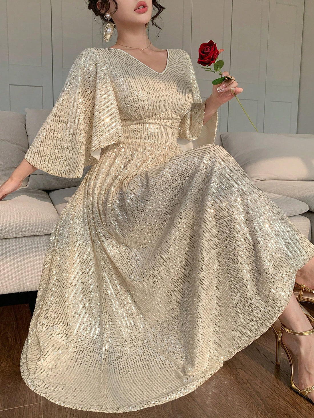 Turn heads at every celebration with this elegant mid-length sequin dress. Featuring a flattering V-neck and charming ruffle sleeves, it adds a fun, flirty touch to your party look. Sparkle effortlessly while enjoying comfort and style that moves with you. Perfect for dancing the night away or making a glamorous entrance!