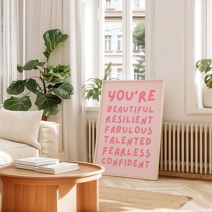 Close-up of coral motivational lettering on blush pink wall art