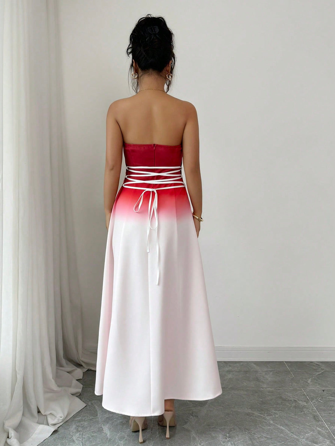 Slip into sophistication with this stunning red ombre bandeau midi dress that's equal parts glamorous and fun. The gradient hue transitions beautifully from deep crimson to lighter shades, while the ruched waist cinches your silhouette for a flattering fit. Playful puff sleeves add a touch of whimsy and dimension to the design. Perfect for date nights, special occasions, or whenever you want to turn heads, this midi-length beauty strikes the ideal balance between elegant and effortlessly chic. A wardrobe es