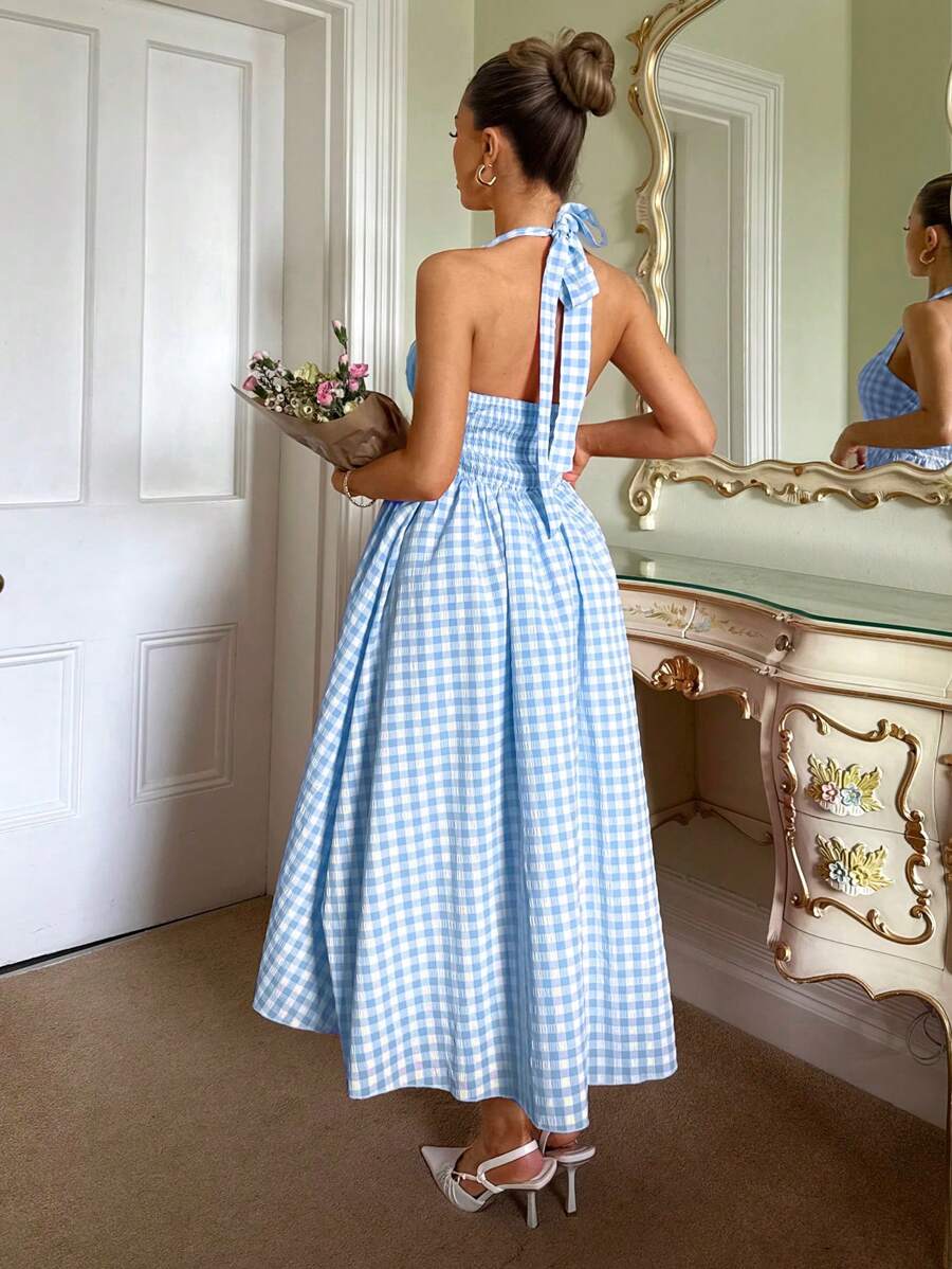 Step into enchantment with this charming pastoral princess dress, where timeless elegance meets modern flair. The fitted bodice hugs your silhouette beautifully before flowing into a graceful swing skirt that twirls with every movement. Crafted in a classic plaid pattern, the halter neckline adds a touch of sophistication while keeping things breezy and comfortable for warm weather. Perfect for garden parties, summer celebrations, or any occasion calling for a dash of whimsy and romance. This dress transfor