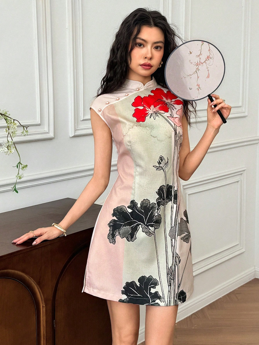 Step into charm and grace with this Floral Print Chinese Style Mini Dress. Featuring flutter sleeves and a classic cheongsam collar, it blends traditional elegance with a flirty, playful vibe. The vibrant floral pattern adds a fresh pop of color, making it perfect for sunny days or festive nights. Its mini length keeps things light and fun, letting you twirl with ease wherever you go.