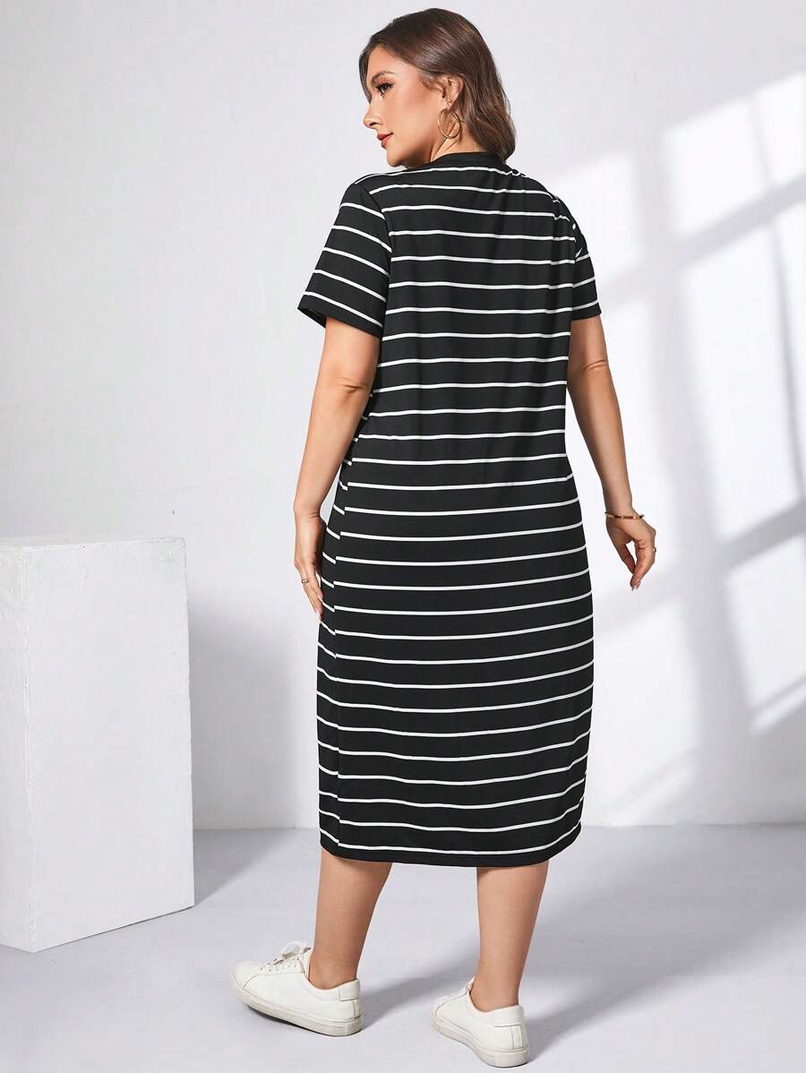 Front outdoor view of plus-size black and white striped side-slit midi dress
