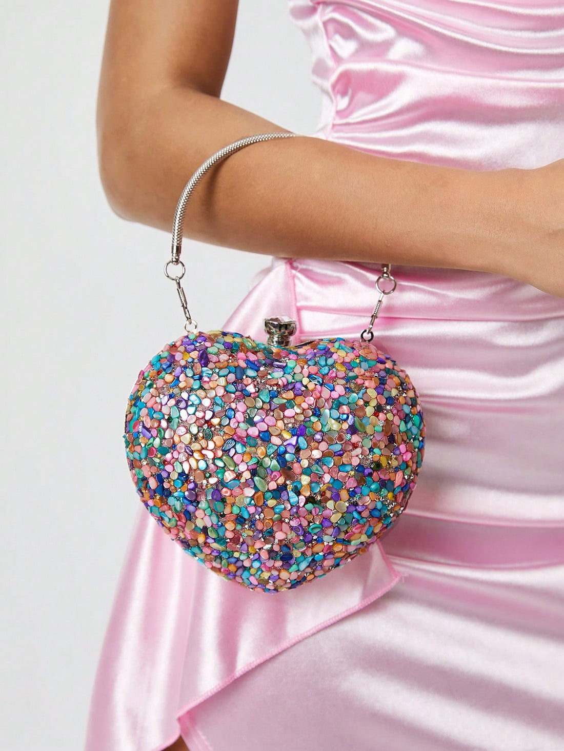 Add a touch of whimsy to your summer look with this elegant heart-shaped acrylic clutch. Perfect for parties or beach getaways, its clear design lets your style shine through while keeping essentials close. Lightweight yet chic, it’s the playful accessory that turns heads wherever you go.