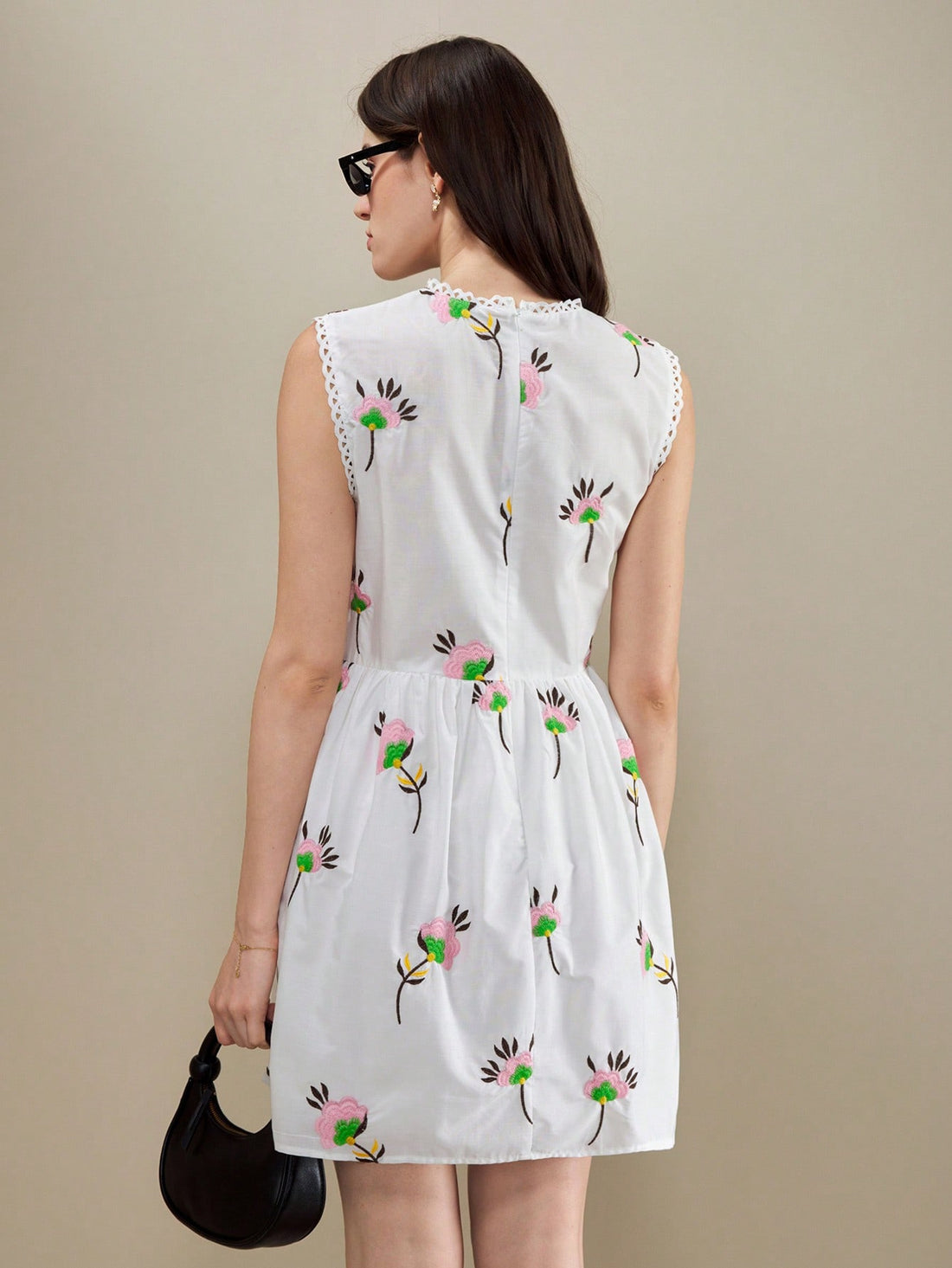 Step into sunshine with this playful white mini dress, featuring delicate embroidery and a flirty ruffled hem. Perfect for summer days and warm evenings, it combines breezy comfort with chic style to keep you feeling light and looking effortlessly elegant. Whether you're strolling the boardwalk or dancing at a garden party, this dress adds a touch of fun sophistication to your wardrobe.