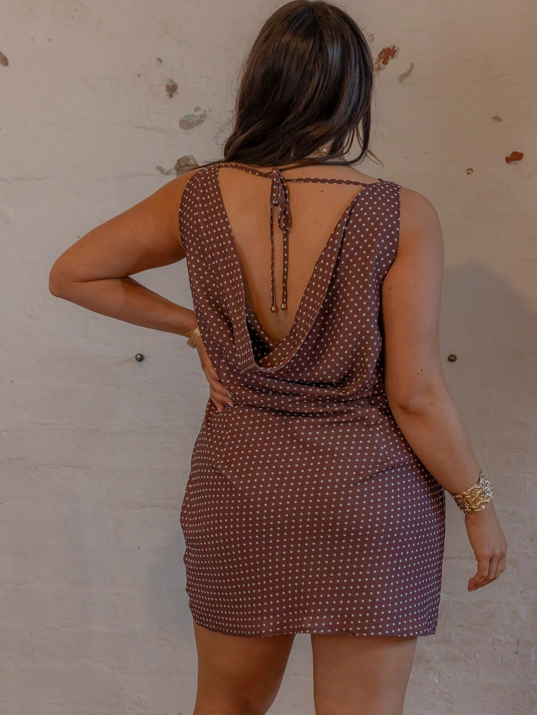 Turn heads at your birthday bash with this playful polka dot mini dress. The curve-hugging bodycon fit and sleeveless cowl neck design combine comfort with flirty style, making it the perfect party outfit. Lightweight and easy to wear, it highlights your silhouette while keeping things fun and festive all night long. Celebrate in style with this charming, statement-making dress that’s as lively as you are!