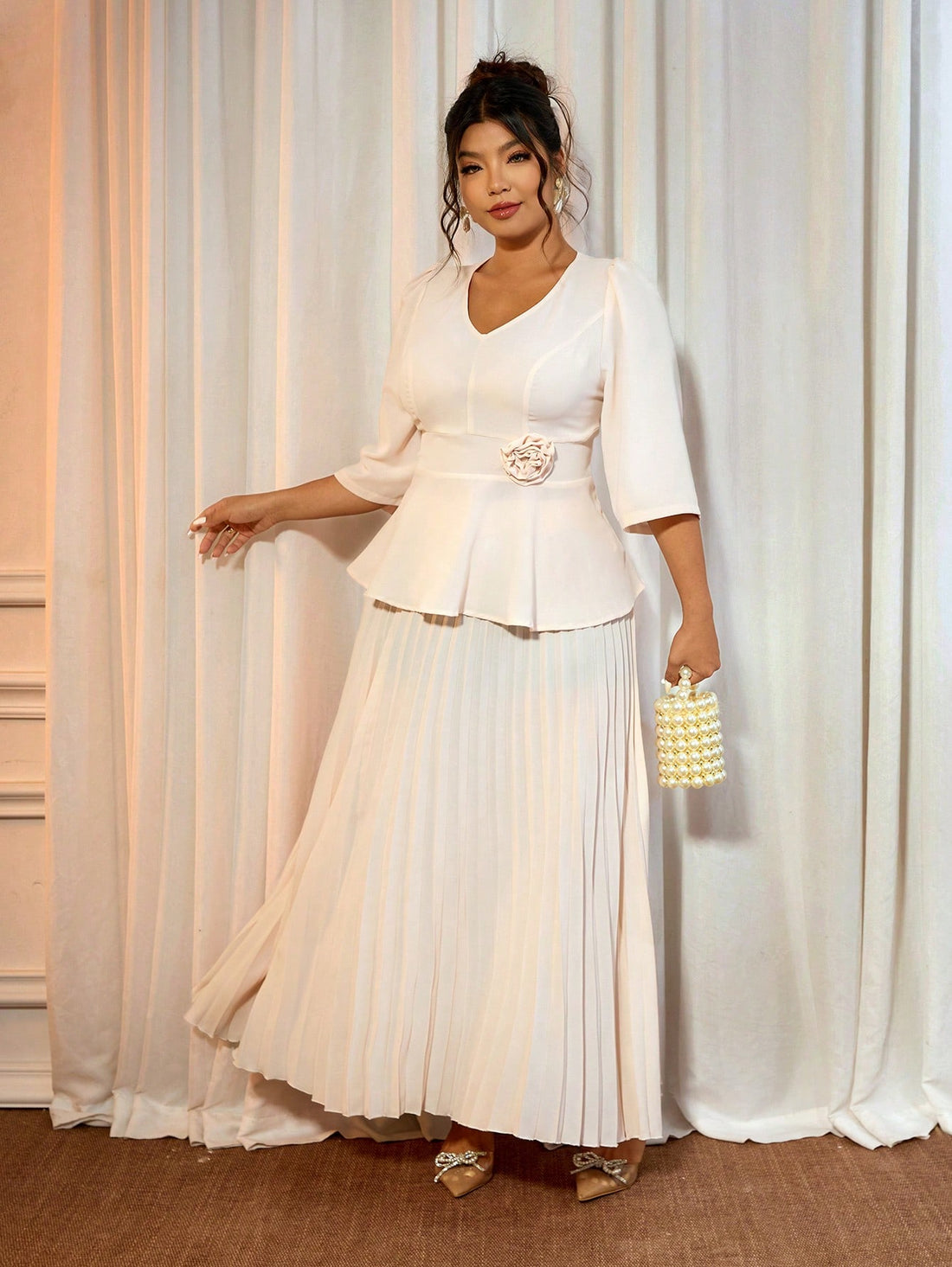 Elevate your formal wardrobe with this stunning two-piece set designed for the modern woman! The soft apricot V-neck shirt drapes beautifully, offering both comfort and sophistication, while the floral-cinched skirt adds a touch of romantic flair. Perfect for weddings, galas, or special celebrations, this plus-size ensemble combines timeless elegance with contemporary style. The cinched waist flatters your silhouette while the coordinated pieces create an effortlessly polished look. Dress it up with heels a