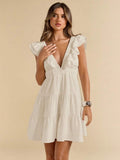 White mini dress with plunging ruffle neckline sleeveless shoulders and tiered flared skirt