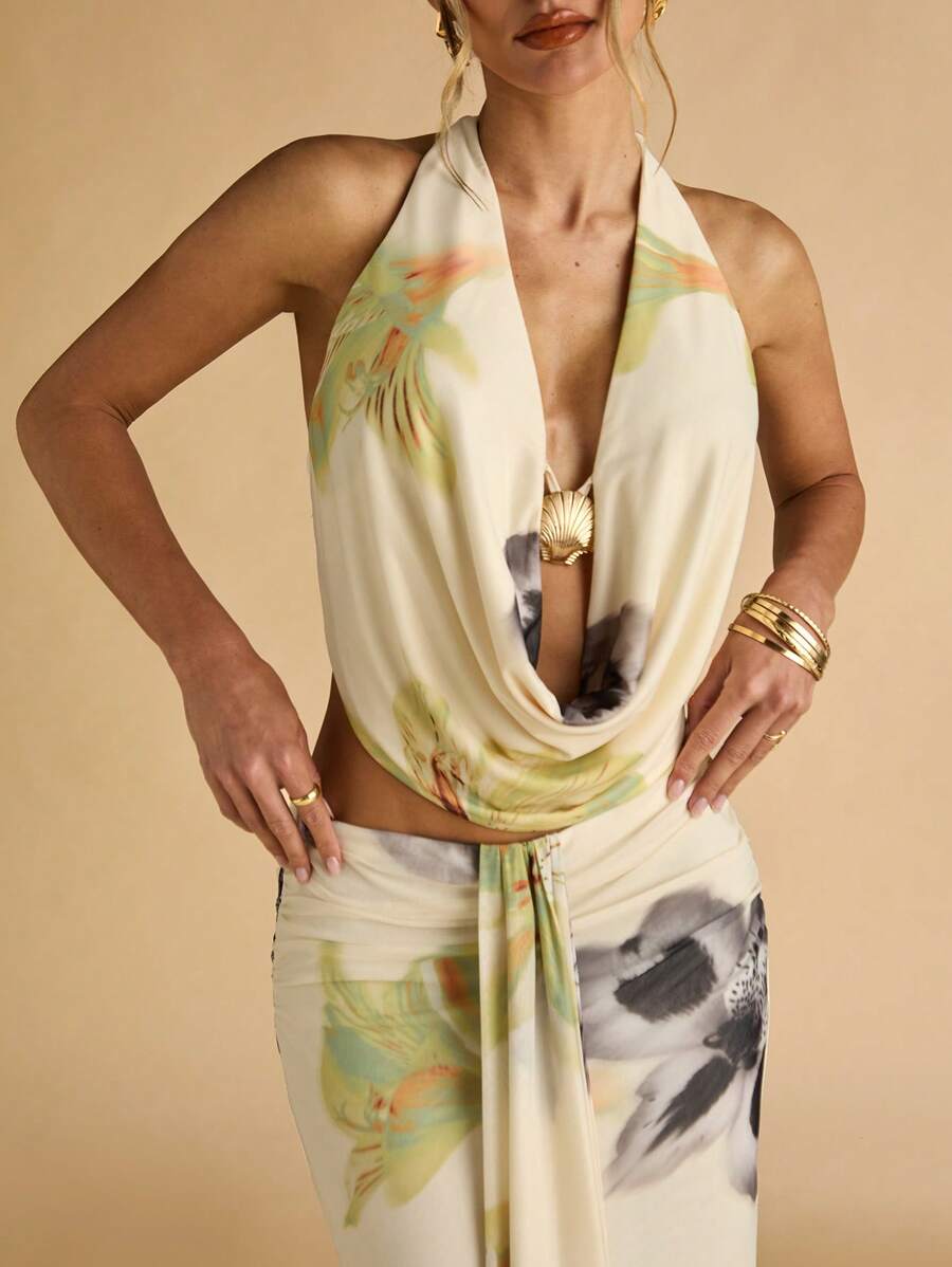 Side view of floral cowl top and slim draped maxi skirt with front sash