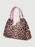 Angled view of patterned hobo shoulder bag with double handles and silver cross detail