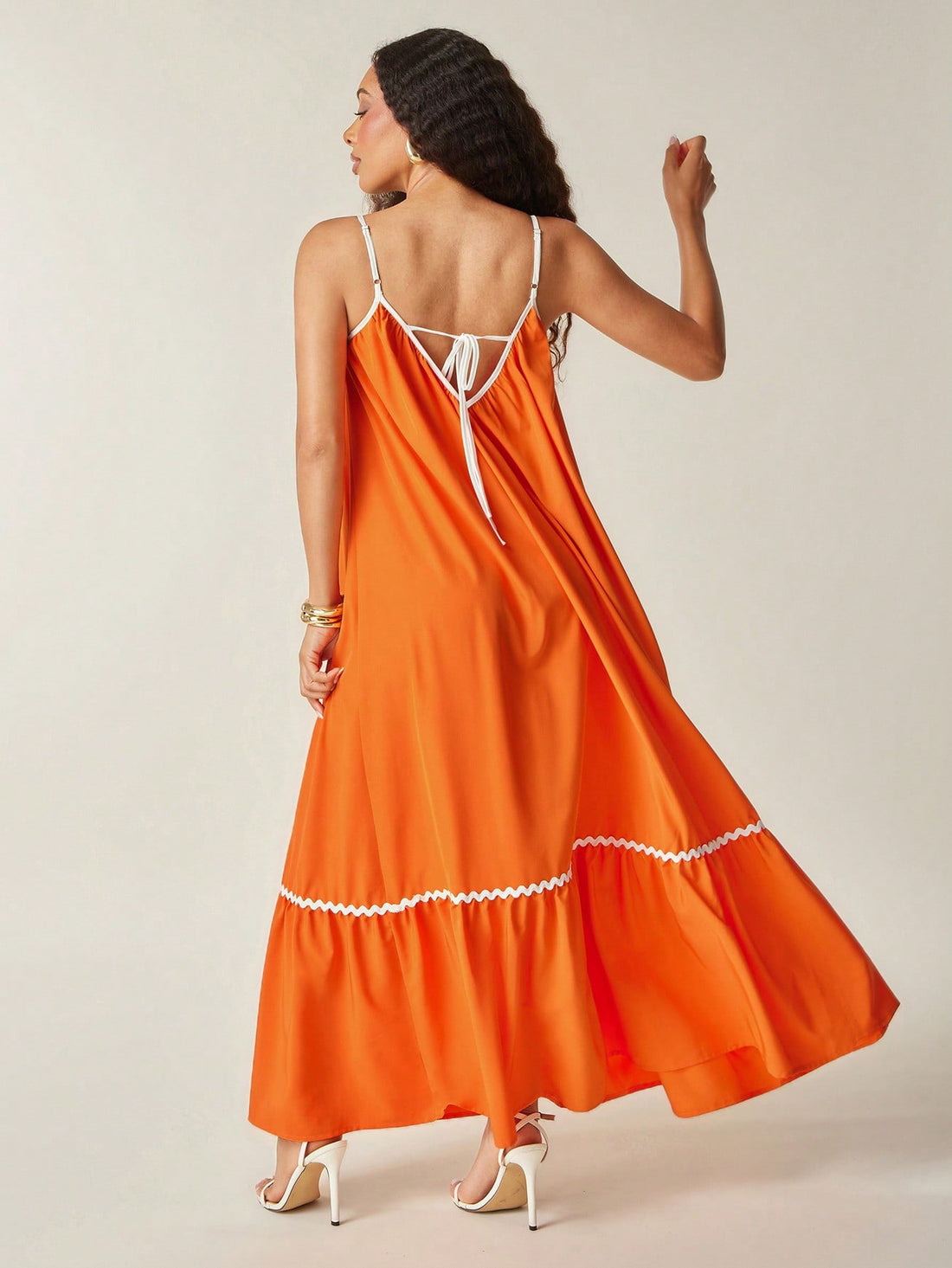 Embrace sunny days in this flowy woven sun dress, designed with a playful ruffle hem and charming wavy trim. Lightweight and breezy, it’s your perfect companion for beach strolls or summer picnics, keeping you cool and effortlessly stylish all day long.