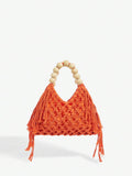 Orange crochet beach bag front view with net knit body side fringe and round bead handle