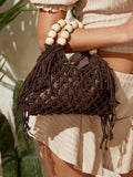 Brown crochet beach bag close up with hollow weave tassels and cream bead handle