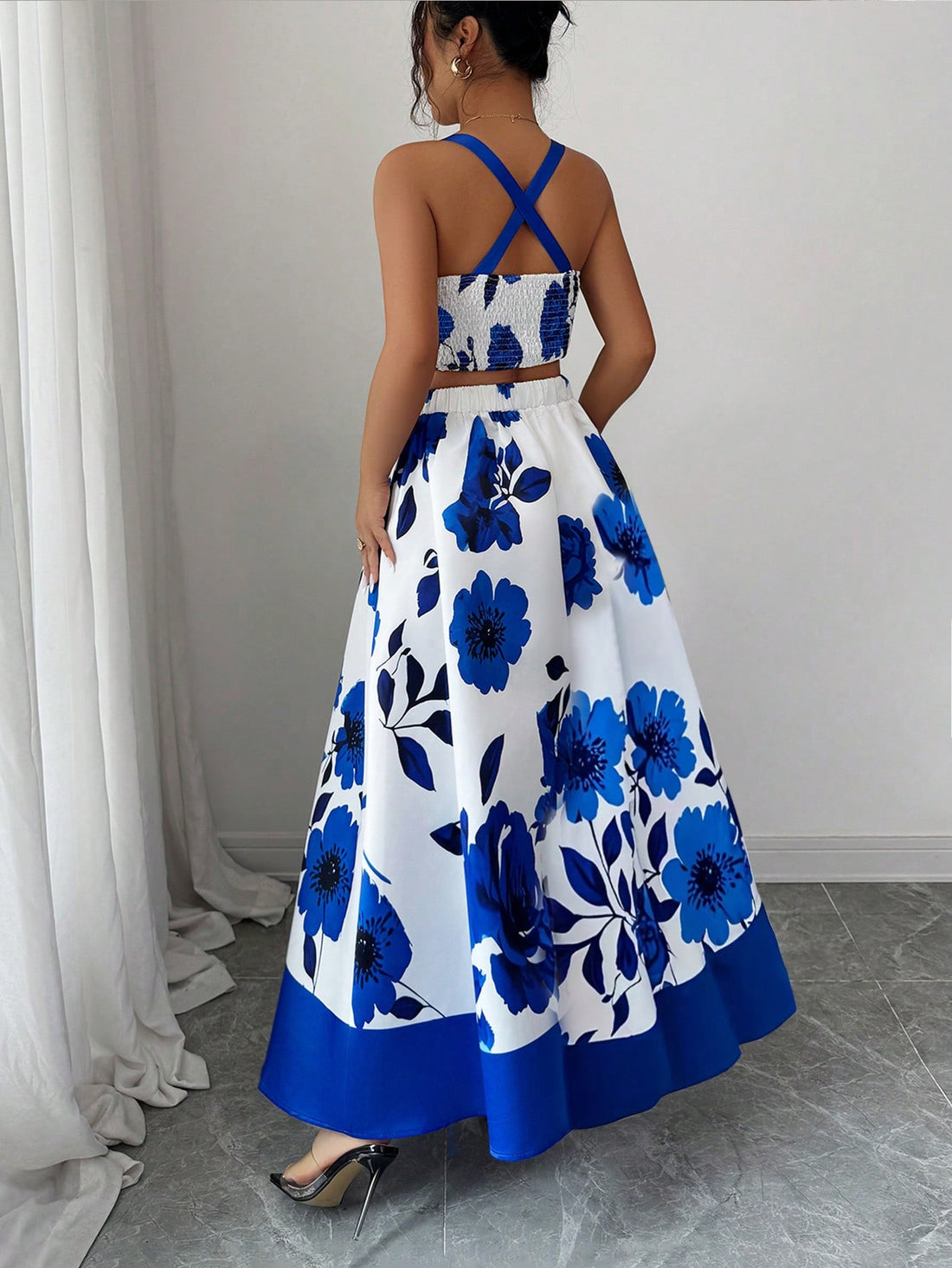 Turn heads on your next getaway with this charming two-piece set! The sleeveless crop top features a delicate floral print that pairs perfectly with the coordinating skirt, creating an effortlessly chic vacation look. Whether you're exploring tropical destinations or enjoying a weekend escape, this set delivers style and comfort in one package. The lightweight fabric keeps you cool while the elegant design works for everything from beachside brunches to evening strolls. Pack it, wear it, love it—your vacati