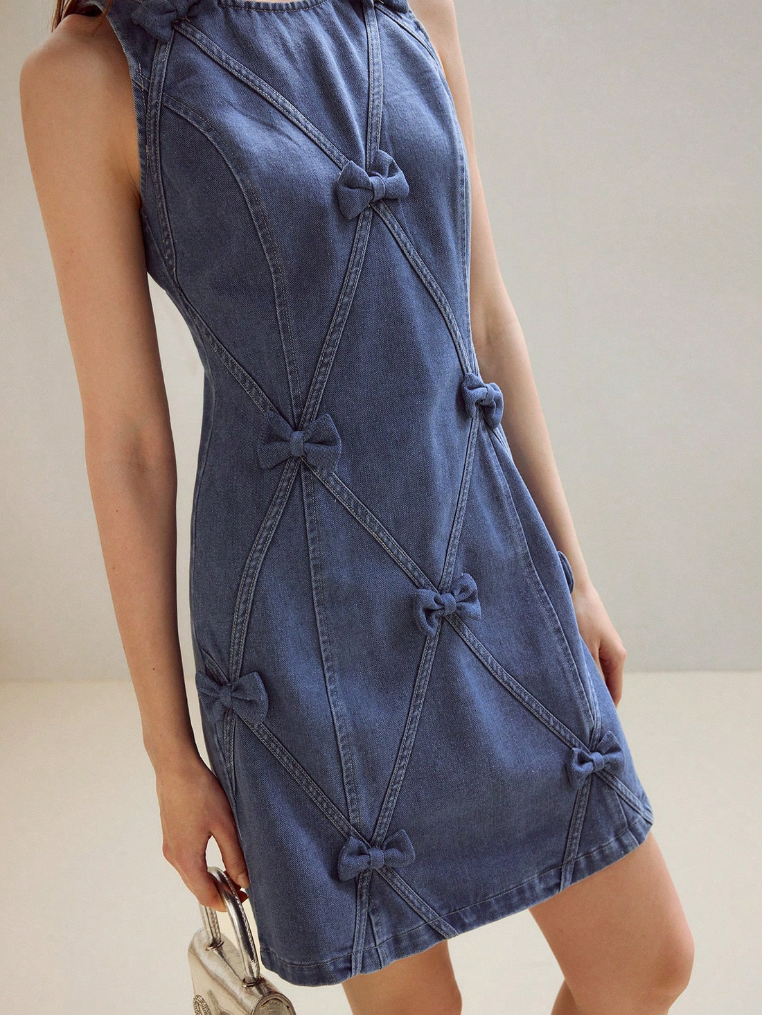 Step out in style with this playful denim dress featuring a charming bow detail and a convenient zipper back. Its chic tank silhouette offers a flattering fit that's perfect for sunny days or casual outings. Easy to wear and effortlessly cute, this dress adds a fun twist to your wardrobe essentials.