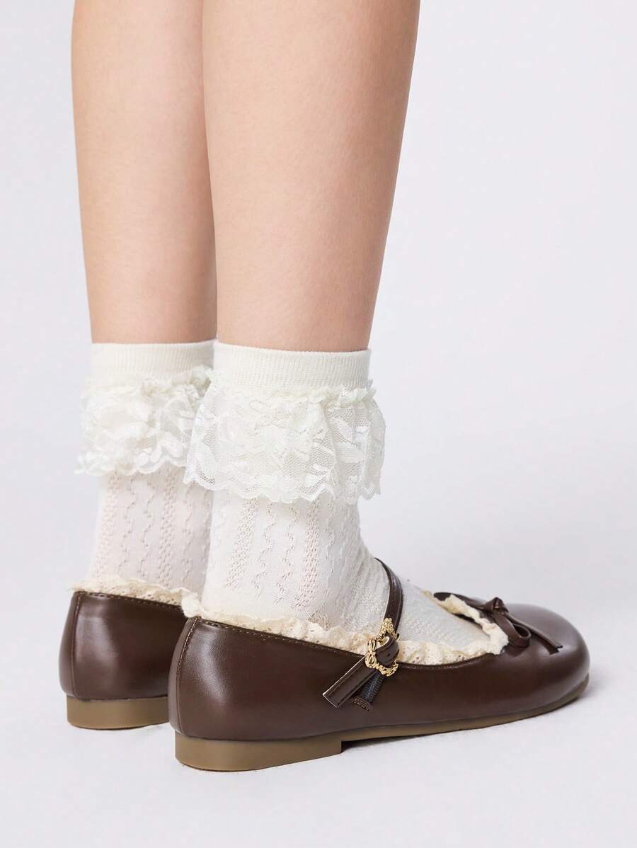 Rear side view of brown Mary Jane flats with buckle straps and low tan soles