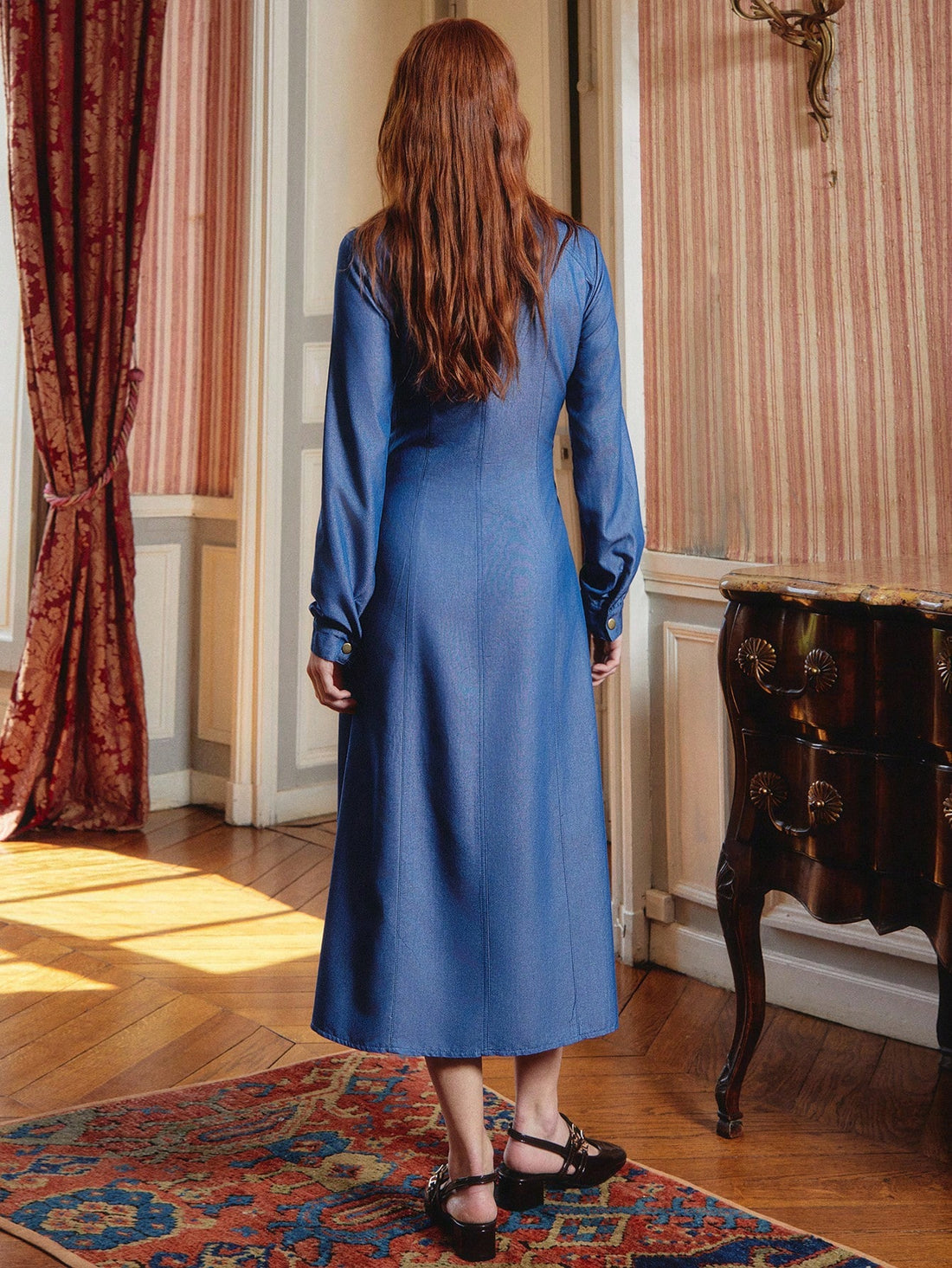 Elevate your workweek wardrobe with this stunning maxi shirt dress that effortlessly bridges the gap between polished and playful. Crafted in a rich blue hue, it features eye-catching gold buttons that add a touch of sophistication to every outfit. The relaxed silhouette drapes beautifully, making it perfect for layering through autumn and winter months. Slip it on over a tee, pair with your favorite boots, or dress it up for the office—this versatile piece does it all. Say goodbye to outfit indecision and 