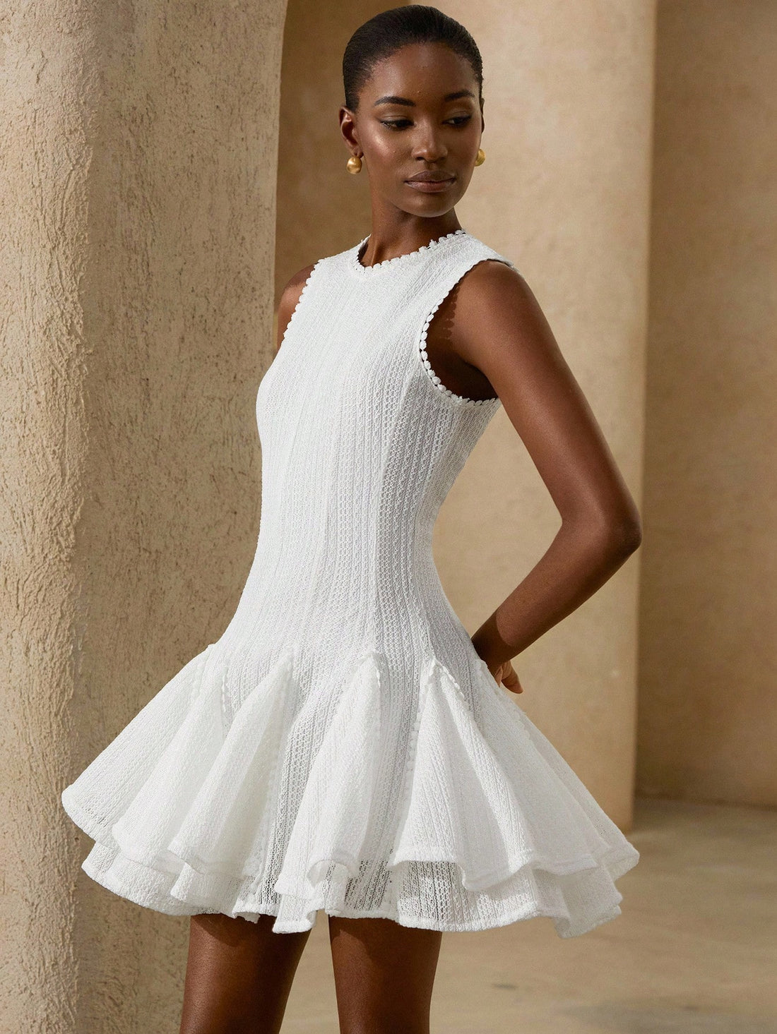 Step into summer with this playful white floral crochet sleeveless dress. Its delicate crochet pattern adds a touch of elegance while keeping you cool and comfortable. Perfect for sunny days and warm evenings, this versatile dress effortlessly blends charm and style for any occasion.