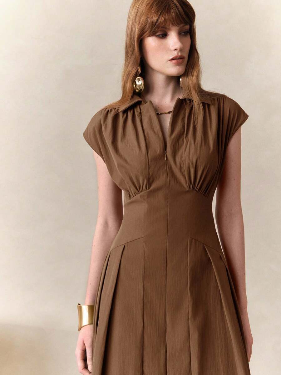 Turn heads at the office or your next outing with this chic olive green bodycon midi dress. Its sleek, sleeveless design hugs your curves while the playful ruffle split adds a flirty twist to classic French elegance. Perfect for the stylish commuter who loves comfort and confidence in one effortlessly elegant package.