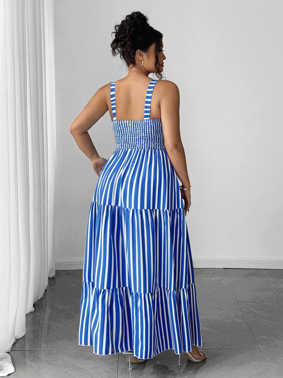 Stripes never go out of style—especially when they're this fresh and flattering! This blue and white vertical striped dress features a cinched waist that hugs your curves in all the right ways, creating an instantly polished silhouette. Perfect for summer days when you want to look effortlessly chic without trying too hard. Pair it with sneakers for casual vibes or dress it up with sandals for a night out. Whether you're heading to brunch, running errands, or catching the sunset, this striped stunner has yo