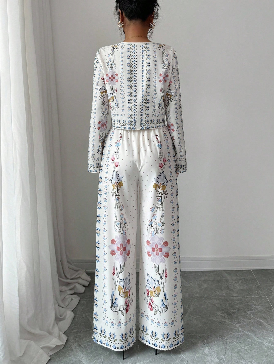 Bloom into autumn with this charming two-piece ensemble that pairs a vibrant floral long-sleeve shirt with coordinating pants. Perfect for fall getaways, this casual suit strikes the ideal balance between comfort and style—no fussy dressing required. The relaxed fit lets you move freely while exploring new destinations, and the botanical print adds a cheerful pop of personality to your travel wardrobe. Whether you're strolling through pumpkin patches or enjoying cozy café moments, this set keeps you looking