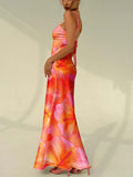 Side back view of backless floral maxi dress with tie straps and flared hem