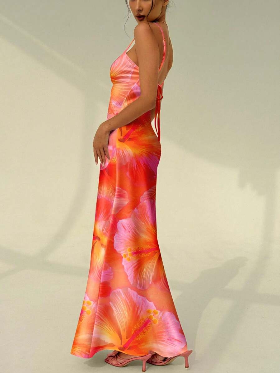 Side back view of backless floral maxi dress with tie straps and flared hem