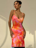Close front view of orange floral maxi dress showing bust cups and hibiscus print