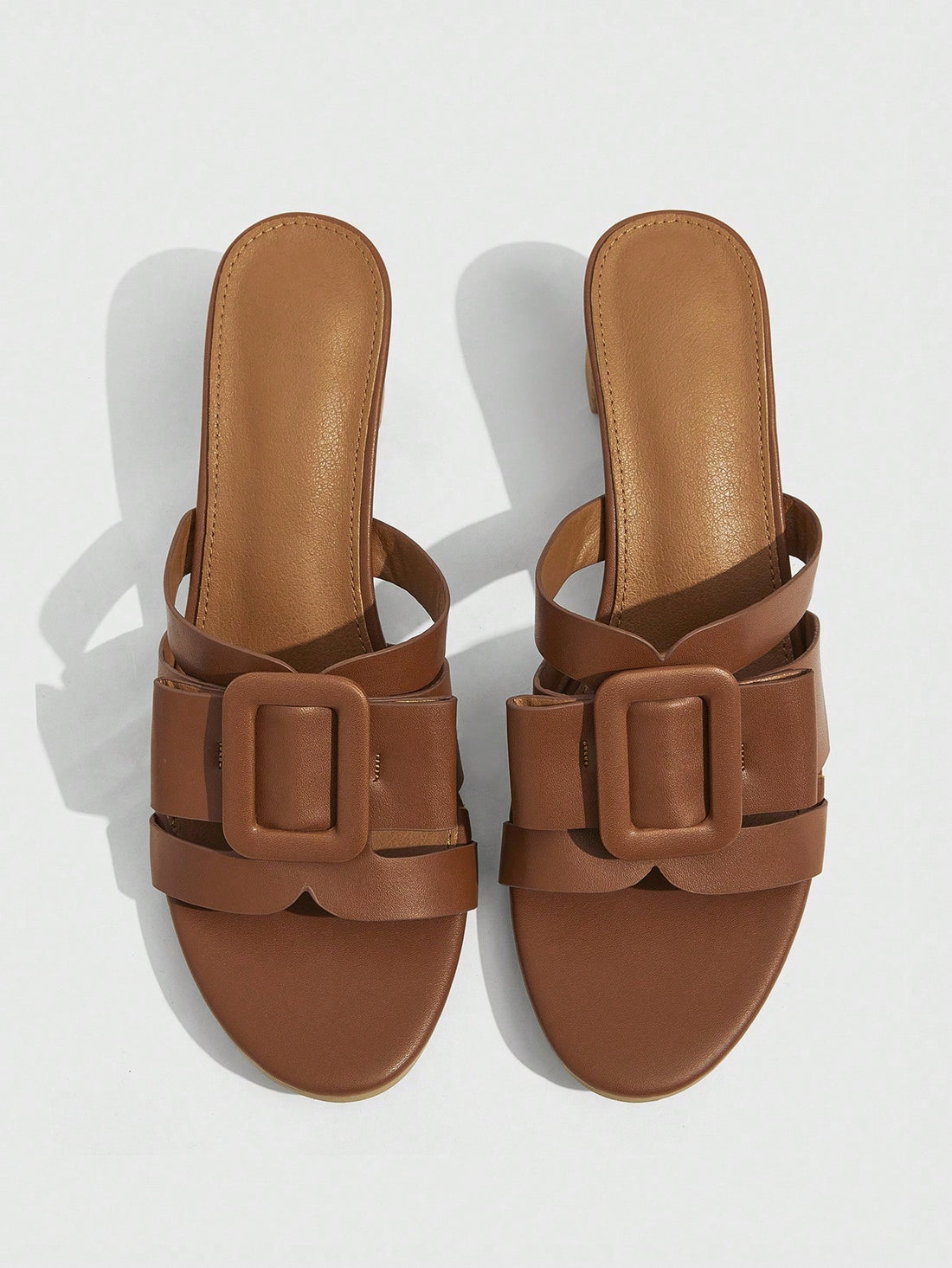 Step into effortless charm with these brown open-toe sandals designed to turn heads. The sturdy thick French heel adds a chic lift while keeping comfort front and center. A stylish square buckle brings a playful twist, making these sandals perfect for sunny days and lively nights alike.