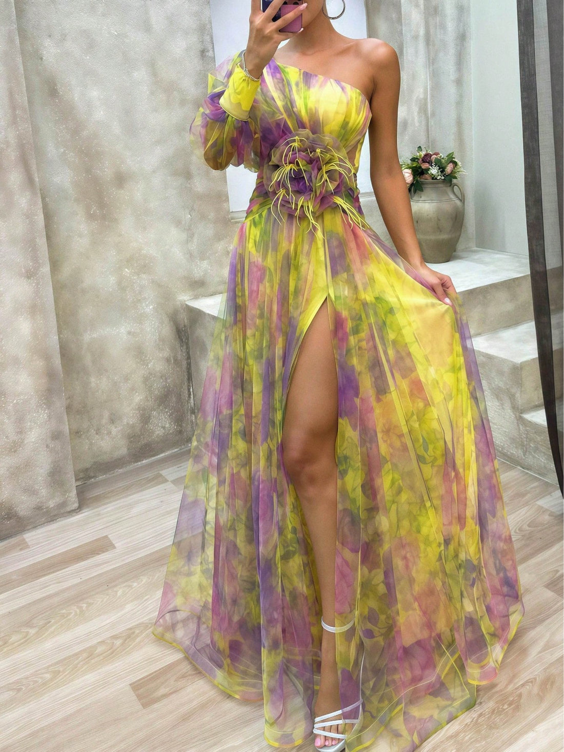 Turn heads at every formal event or garden party with this playful one-shoulder maxi gown. The charming 3D floral appliqué adds a whimsical touch, while the high slit brings a flirty edge to your look. Flowing and graceful, it’s perfect for dancing the night away or stealing the spotlight wherever you go. Embrace elegance with a fun twist!