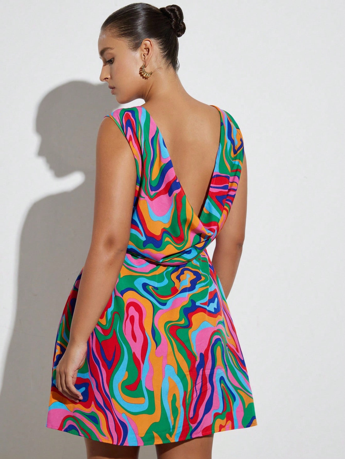 Step into vacation mode with this Chic Plus Size Abstract Camo Print Mini Dress. Its playful camo pattern adds a fun twist to your getaway wardrobe, while the flattering mini cut keeps things flirty and fresh. Perfect for beach strolls or casual dinners, this dress combines comfort and style effortlessly. Embrace your curves and make every moment a stylish adventure!