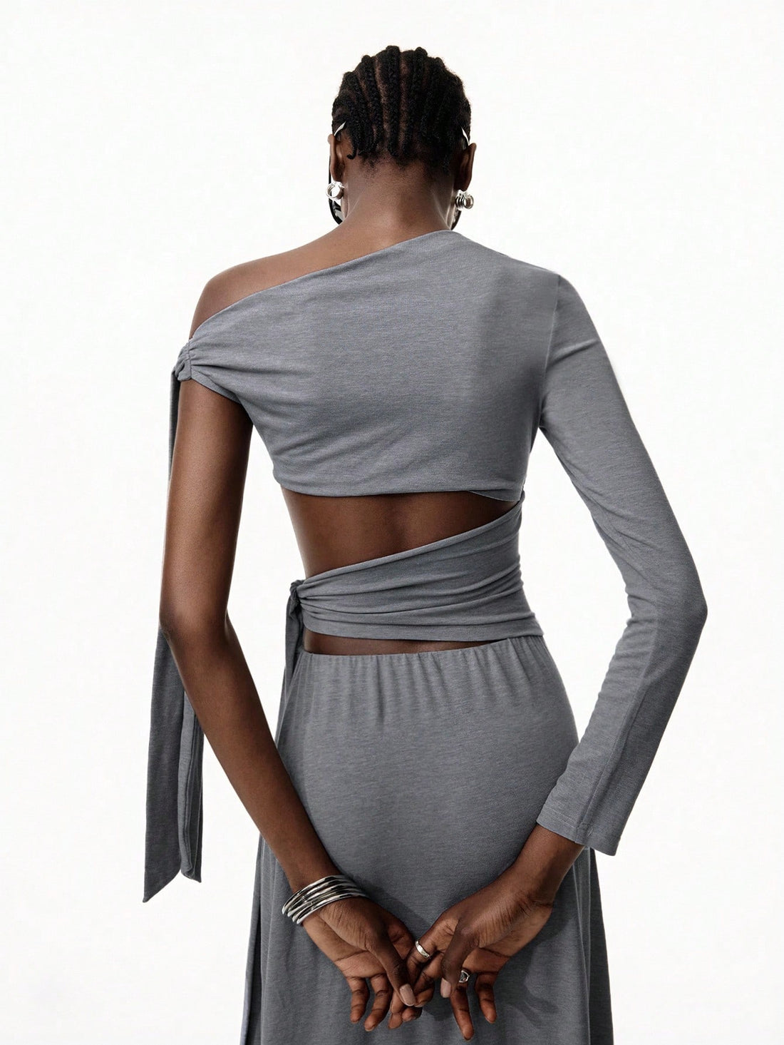 Step into the spotlight with this Minimalist Gray Hollow Strap One-Piece Dress, perfect for Y2K-inspired nightclub vibes or a chic vacation look. Its sleek design and subtle cutouts add a flirty edge while keeping things effortlessly cool. Whether dancing the night away or strolling seaside, this dress blends comfort and style with a playful twist.