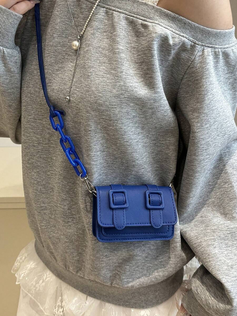 Lifestyle detail of mini color block crossbody bag with polished acrylic accent