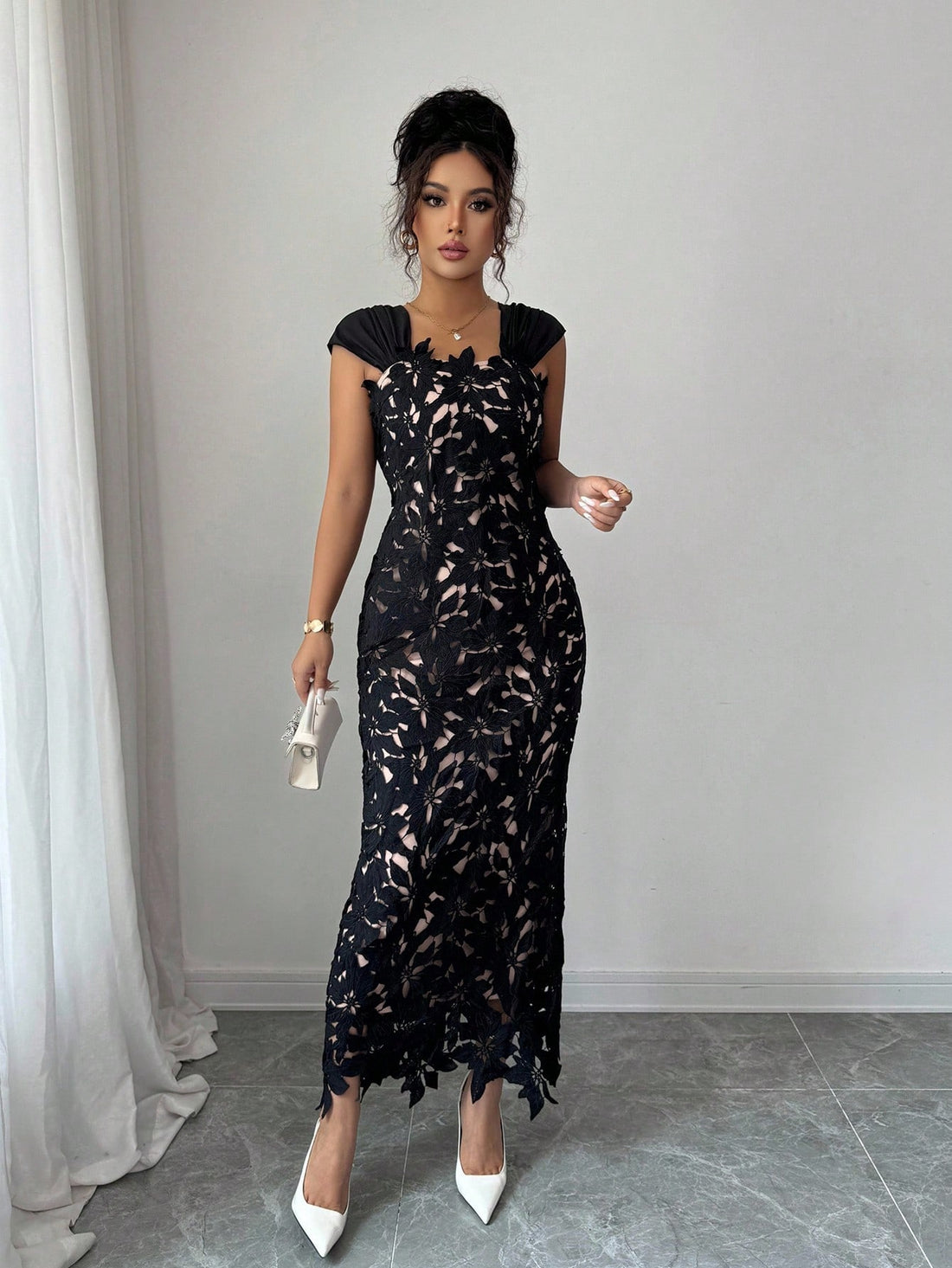Make a statement at your next formal affair in this stunning black evening dress. Intricate floral embroidery adorns the silhouette while strategic hollow-out details add modern sophistication and visual intrigue. The refined design flatters your figure while the luxe fabric drapes beautifully, ensuring you'll feel as fabulous as you look. Perfect for galas, weddings, and upscale celebrations where elegance meets edge.