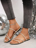 Top view of gold rhinestone strap flat sandals with padded footbed