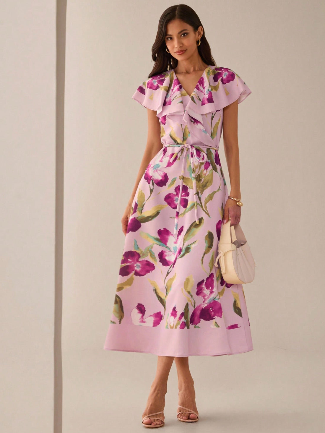 Step into sunshine with this playful mid-length summer dress, blooming in a charming orchid and hibiscus print. Its breezy fabric and flattering cut keep you cool and confident, perfect for garden parties, beach strolls, or casual days out. Embrace the season with effortless style and a splash of floral fun.