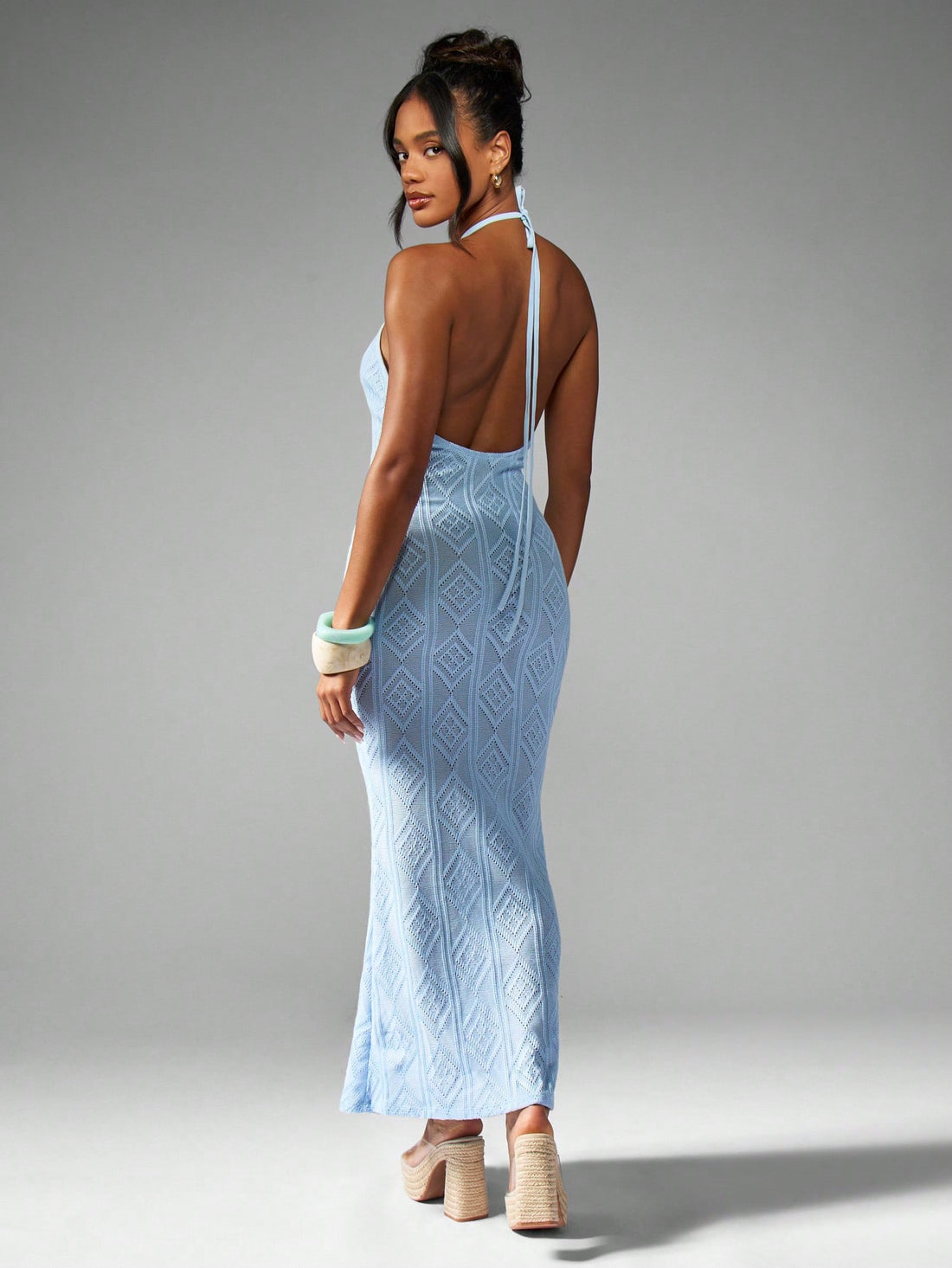 Turn heads this summer in our Elegant Halter Neck Knit Maxi Dress, featuring a charming diamond pattern that's perfect for beach days and resort escapes. The halter neck design adds a flirty touch while keeping you cool and comfortable in the sun. Lightweight and breezy, this dress moves with you, making it your go-to for effortless style and endless fun by the shore.