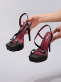 Black strappy stiletto platform sandal view 1 with open toe and ankle strap