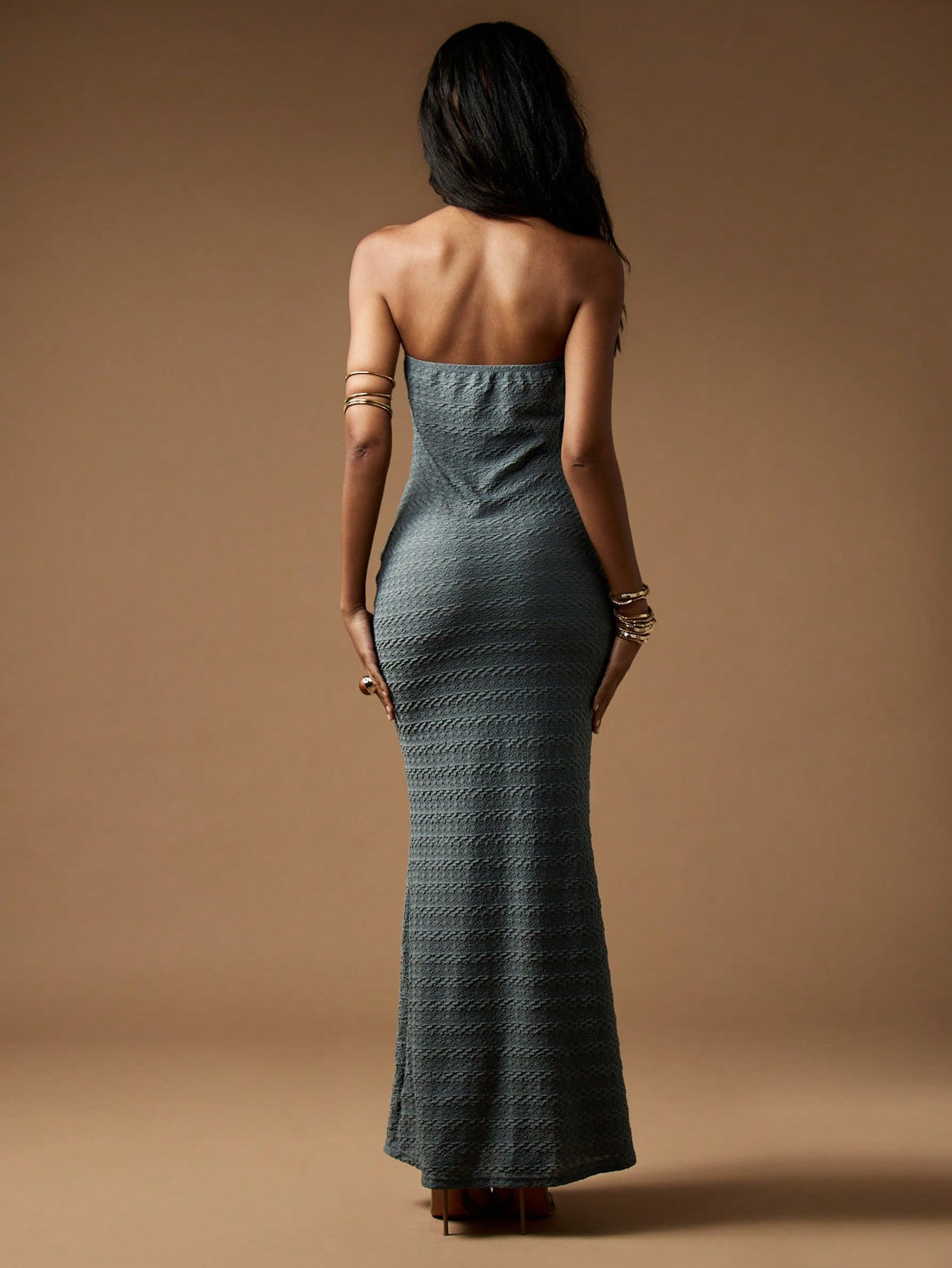 Make a dazzling entrance with this strapless bandeau maxi gown, featuring elegant gold detailing that catches every eye. Its flowing silhouette moves gracefully, perfect for weddings or any special occasion where you want to shine. Feel confident and stylish while turning heads with this effortlessly glamorous dress.