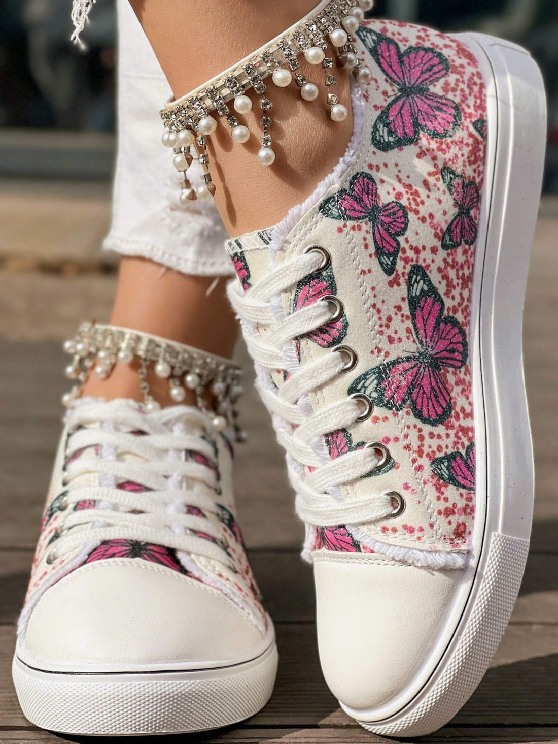 Step out in style with these playful pink sneakers featuring delicate butterfly embroidery and a touch of glitter. Designed for everyday comfort, their low-top silhouette pairs perfectly with casual outfits, adding a fun and feminine flair to your look. Whether you're running errands or meeting friends, these sneakers bring a cheerful pop of color and sparkle to every step.