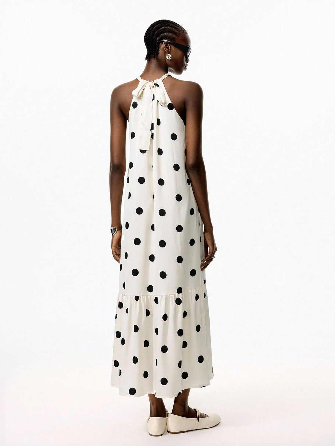 Turn heads on your getaway with this playful polka dot halter maxi dress. Its ruffled hem adds a flirty touch, while the breezy silhouette keeps you comfortable from beach strolls to sunset dinners. Effortless style meets vacation-ready charm in one chic dress.