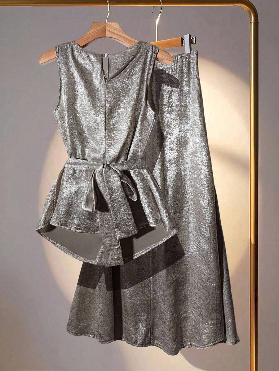 Elevate your wardrobe with this show-stopping two-piece set that effortlessly blends sophistication with fun! The asymmetrical draping blouse creates flattering, dynamic lines that move beautifully with you, while the metallic glitter midi skirt adds just the right amount of sparkle for those moments when you want to shine. Perfect for date nights, celebrations, or whenever you're ready to turn heads. Mix, match, or wear together—this versatile duo works hard so you don't have to think twice about looking f