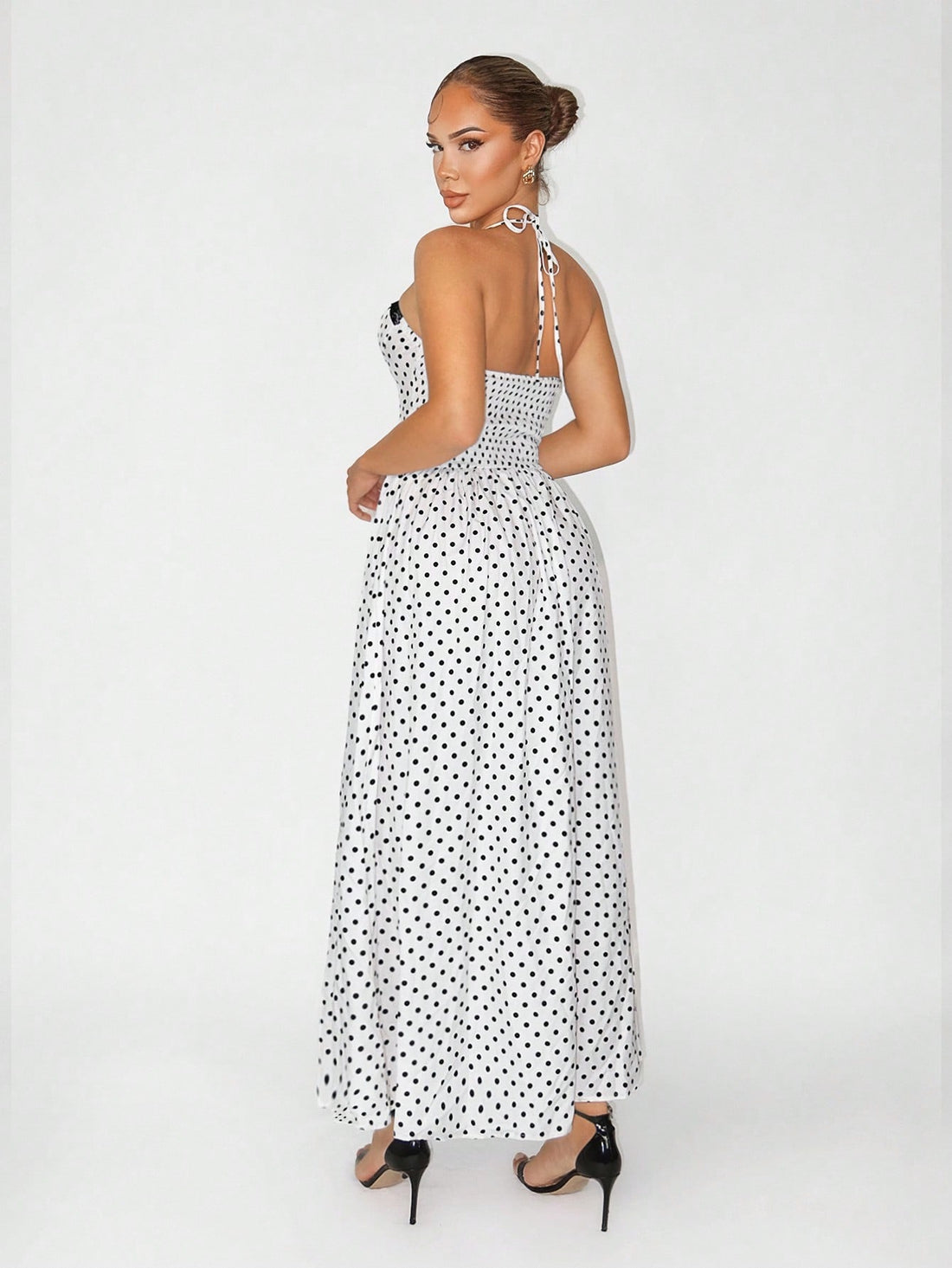 Twirl into vacation mode with this stunning long polka dot dress that effortlessly blends timeless elegance with playful charm. The classic black and white palette pairs perfectly with any occasion—from beachside getaways to evening soirées. Crafted for comfort and style, this dress features a flattering silhouette that moves beautifully with you. Whether you're sipping cocktails by the pool or exploring a new destination, this versatile piece is your go-to for looking polished and put-together. Pack it, we