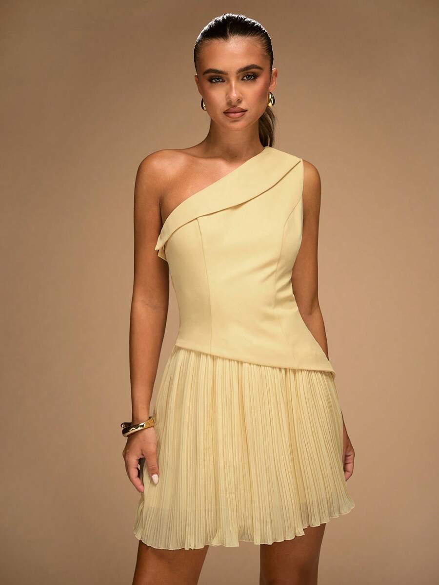 Pale yellow mini dress with asymmetric neckline fitted bodice and pleated skirt